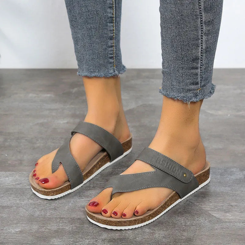 Flat thick-soled toe ring flip-flops in blue, showing artificial PU upper and foam sole.