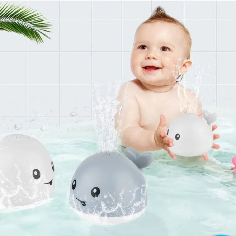 Electric whale-shaped bath spray toy with water-activated automatic spray, LED lights, and floating capability
