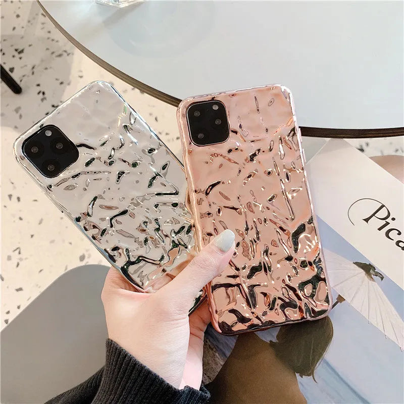 Electroplated rose gold TPU folded back case for iPhone on a table.