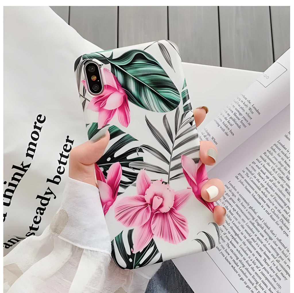 Pink floral pattern TPU back cover case for iPhone models on a table.