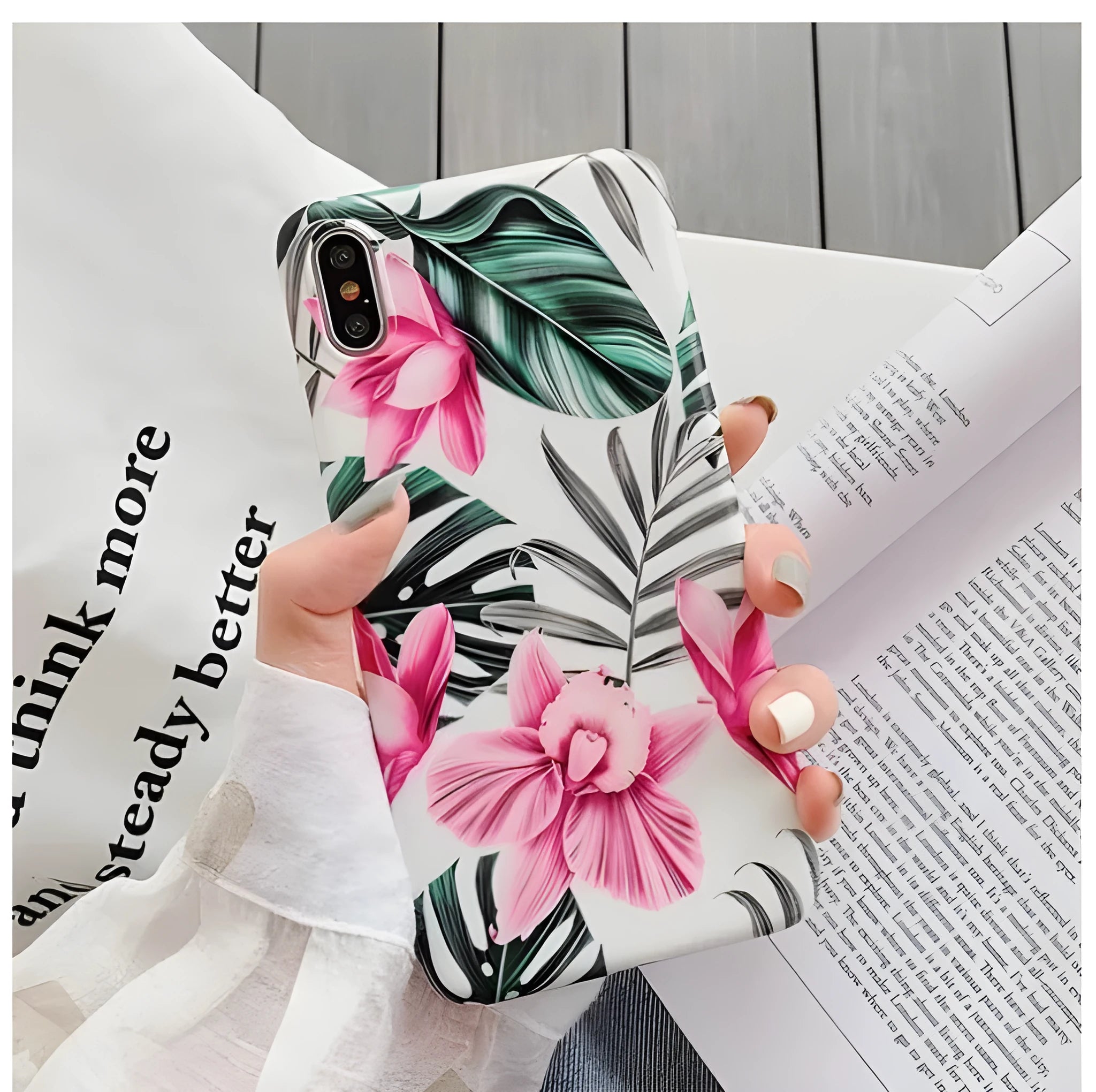 Pink floral pattern TPU back cover case for iPhone models on a table.