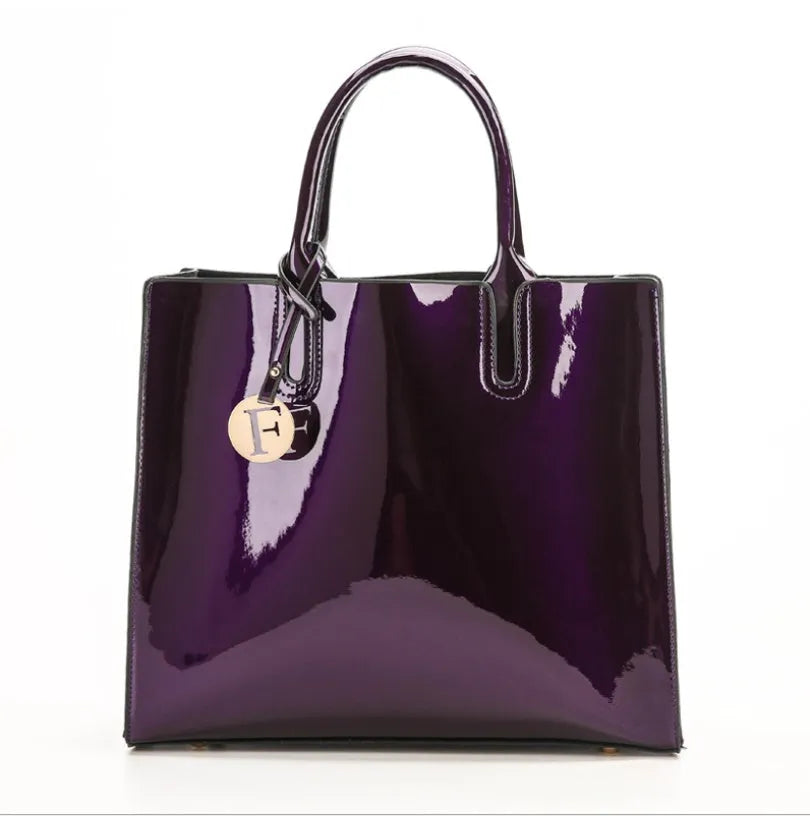 Three soft patent leather handbags in solid colours for women, shoulder and crossbody style with zipper closure