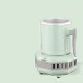 White quick-cooling aluminium cup on its electronic base station with power adapter