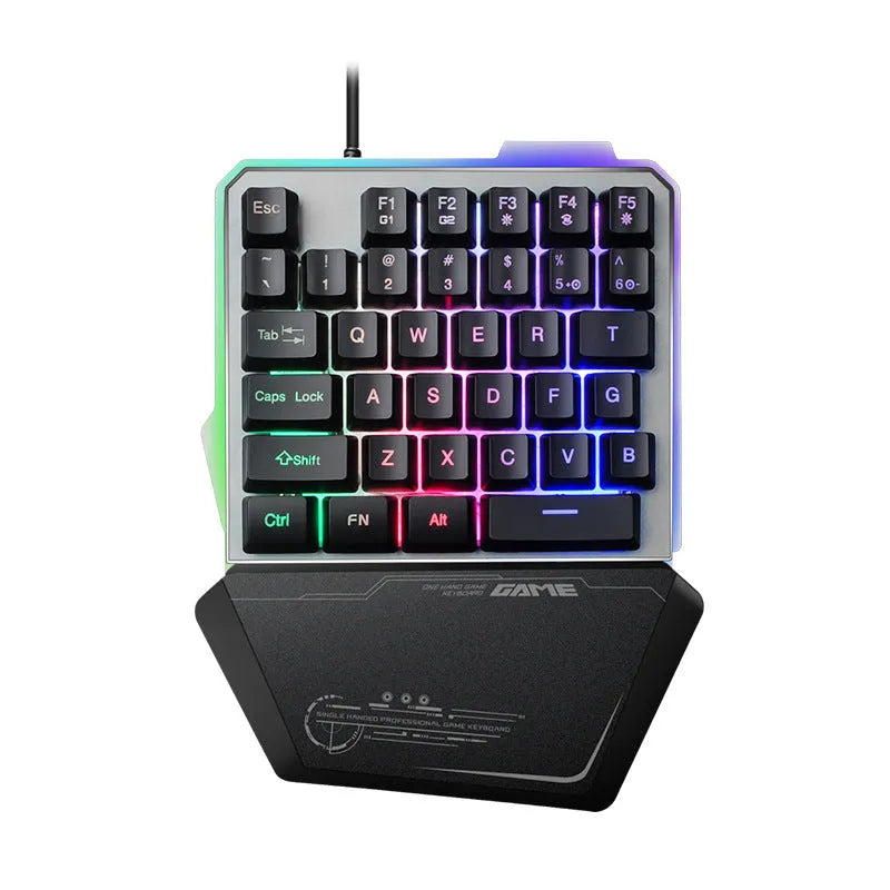Black robotic one-handed keyboard with RGB backlit keys on a desk.