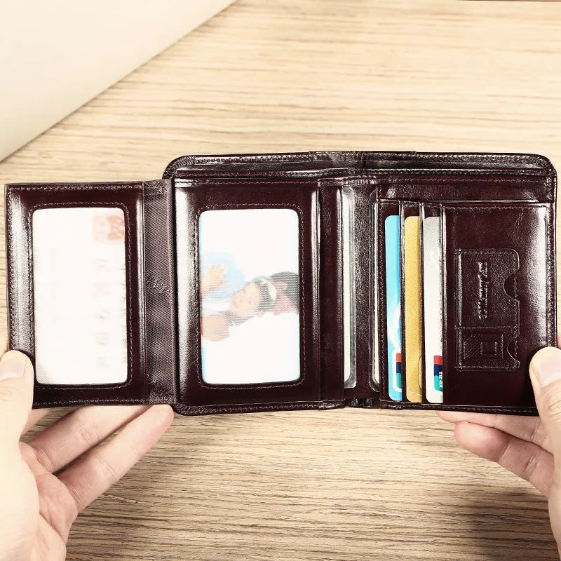 Men's black full-grain leather bifold wallet open, showing card slots, note pocket, and zipped coin compartment.