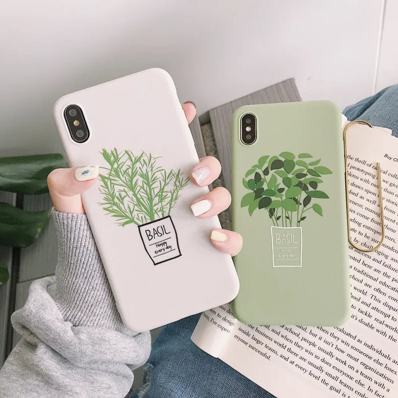 White silicone iPhone case with a detailed painted plant design on the back, showing the smooth texture and enclosed edges.