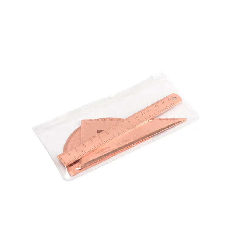 Rose gold and yellow stainless steel ruler set with protractor, triangle, and straightedge in transparent pocket