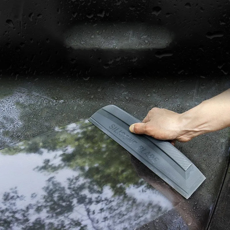 One-piece black silicone car wash wiper with flexible handle on car bonnet