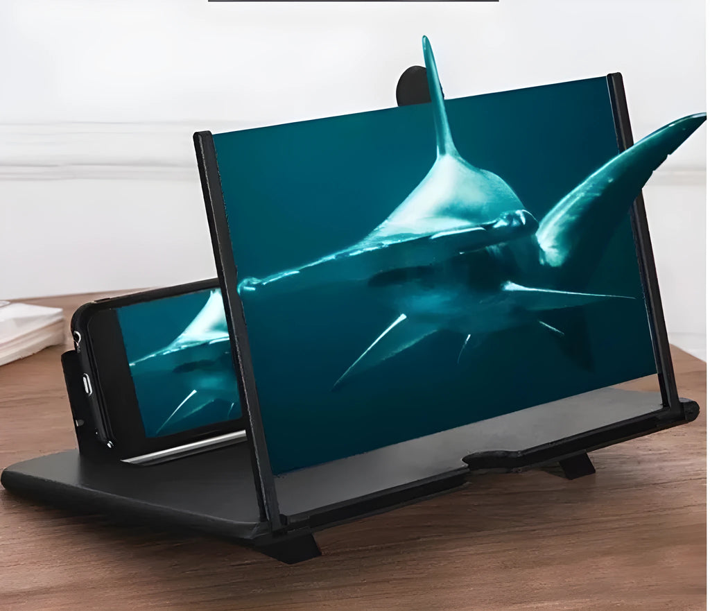 Black foldable phone screen amplifier with fenier lens, 3-4x magnification, on a table