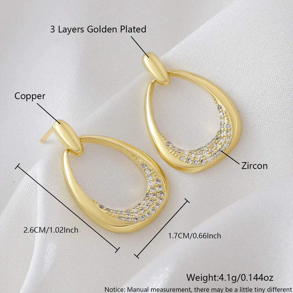 Yellow gold geometric drop earrings with zircon accents measuring 2.6cm x 1.7cm