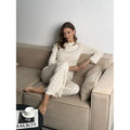 Women's white floral print two-piece suit with bell sleeve top and wide leg pants