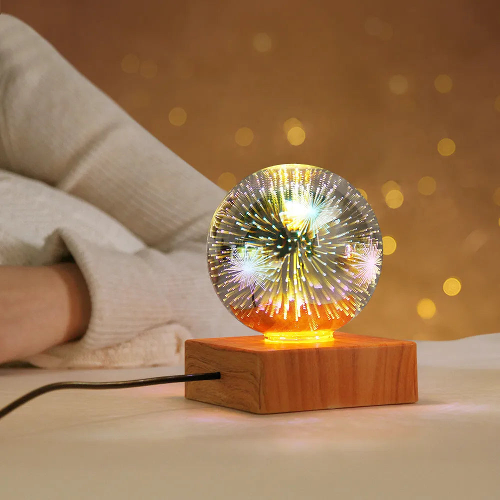 USB plug-in crystal ball night light displaying colourful firework pattern on a dark surface.