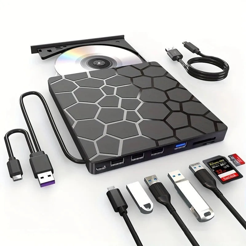 Black portable external USB CD/DVD drive and writer on a desk next to a laptop
