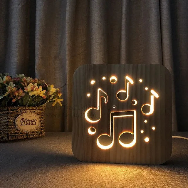 Square pine wood USB LED lamp with warm white light on a wooden desk next to a laptop.