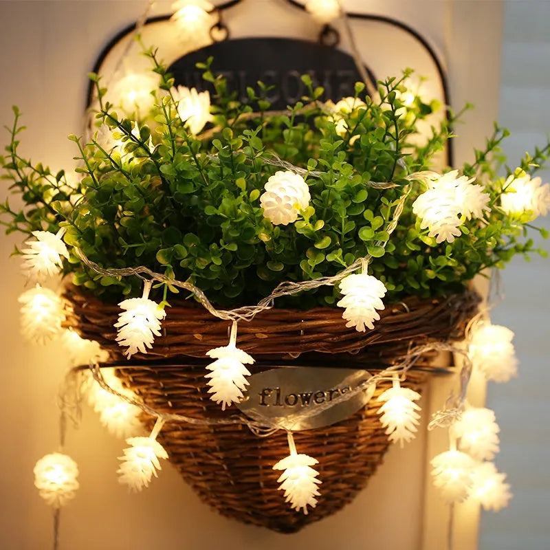 Warm white battery-operated LED pine cone string lights for decoration, showing plastic shell design.