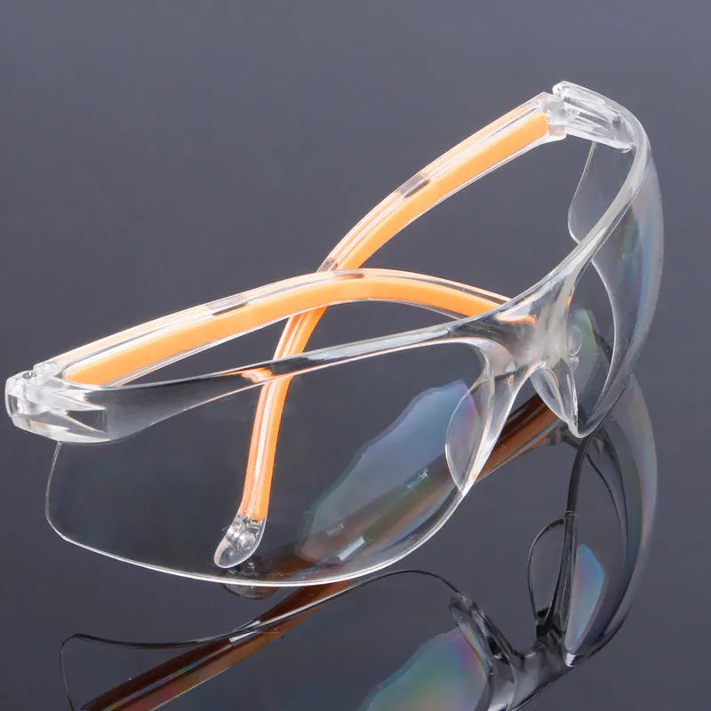Transparent polycarbonate safety goggles with yellow frame for industrial and lab eye protection.