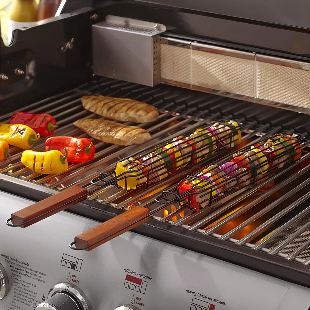 BBQ grill mesh basket with rotary lid and long wood handle placed on a metal grill outdoors