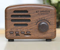 Vintage-style Bluetooth speaker with wood grain finish, showing compact size and front speaker grill.