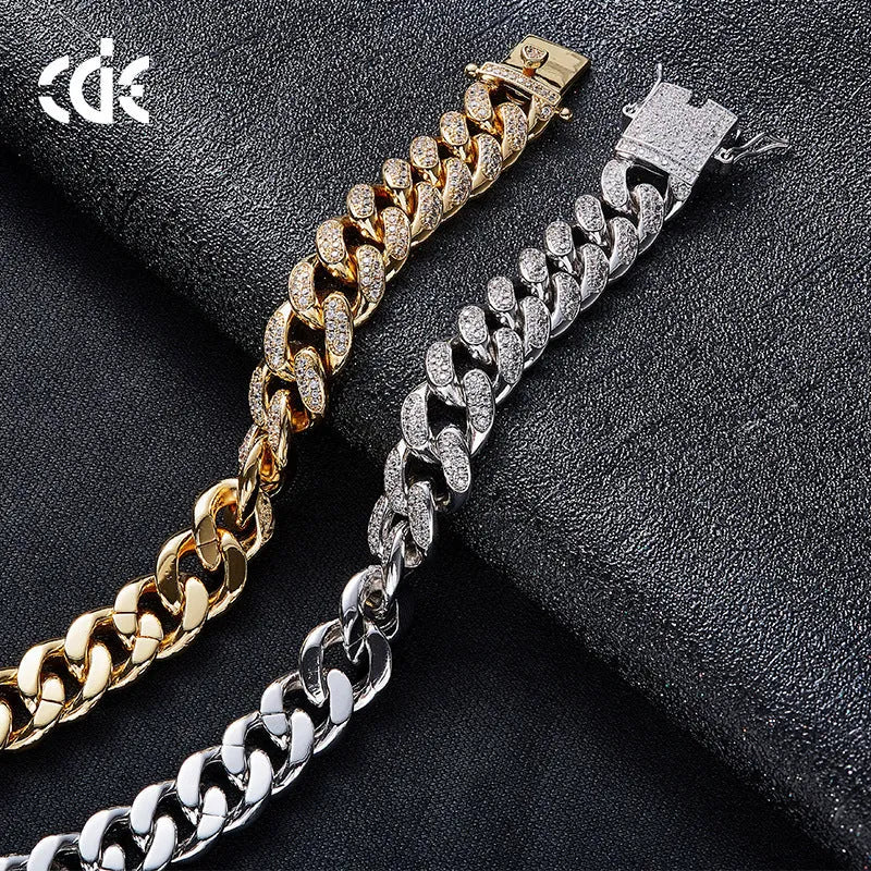 Men's gold Cuban chain bracelet with geometric alloy pendant set with a zircon stone on a neutral background