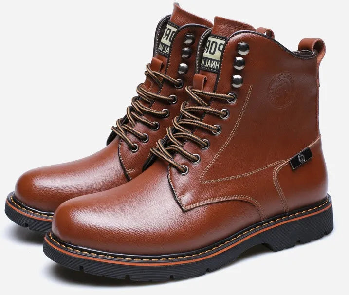 Men's brown embossed leather Martin boots with mid-top cut, round toe, thick heel, and front strap on a wooden floor
