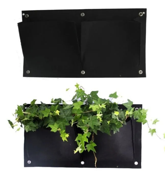 Green felt vertical wall garden planter with multiple planting pockets hung on an outdoor fence.