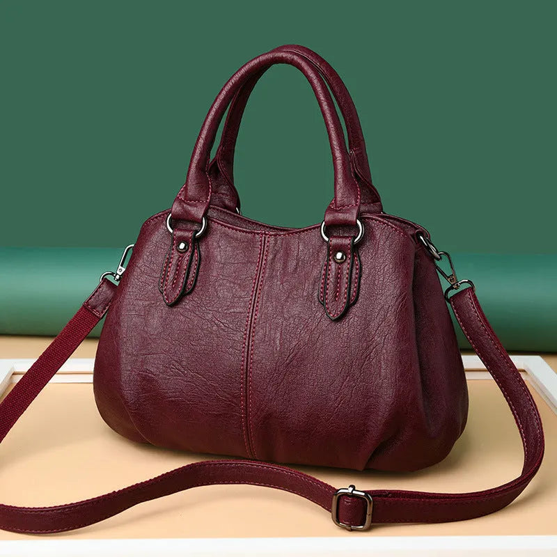 Large capacity crossbody backpack in dumpling shape with PU material and visible sewing line detailing
