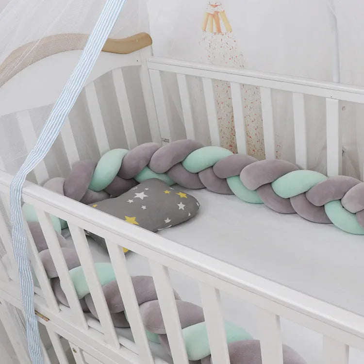 Long, flexible baby crib bumper pillow in spandex velvet, shown fitted around a white cot for safety protection.