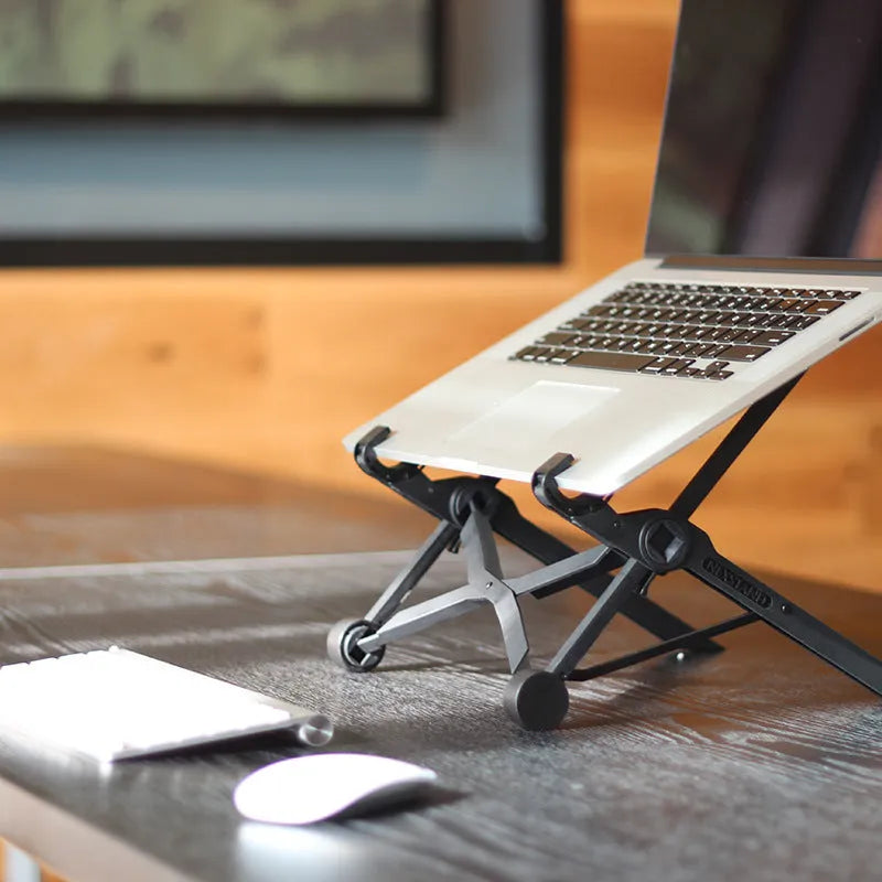 Black folding laptop computer stand with reinforced nylon construction showing folded position at 35.4cm length