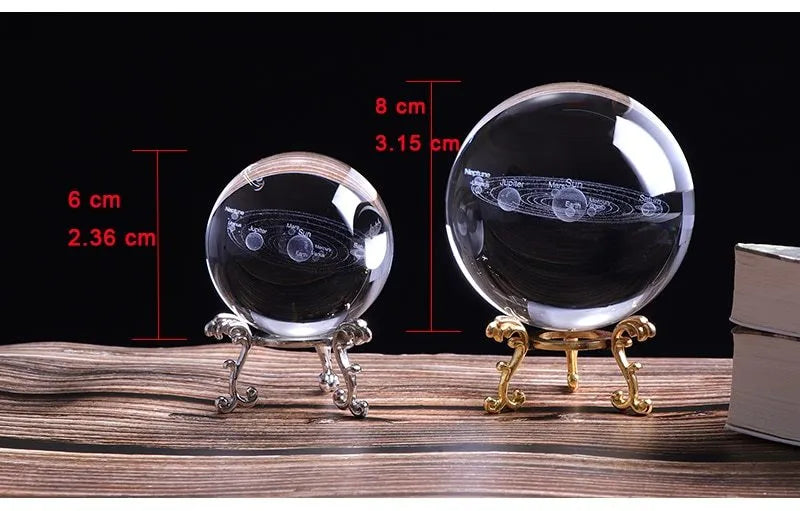 Solar system laser-engraved inside K9 crystal ball on a wooden desk beside an LED base