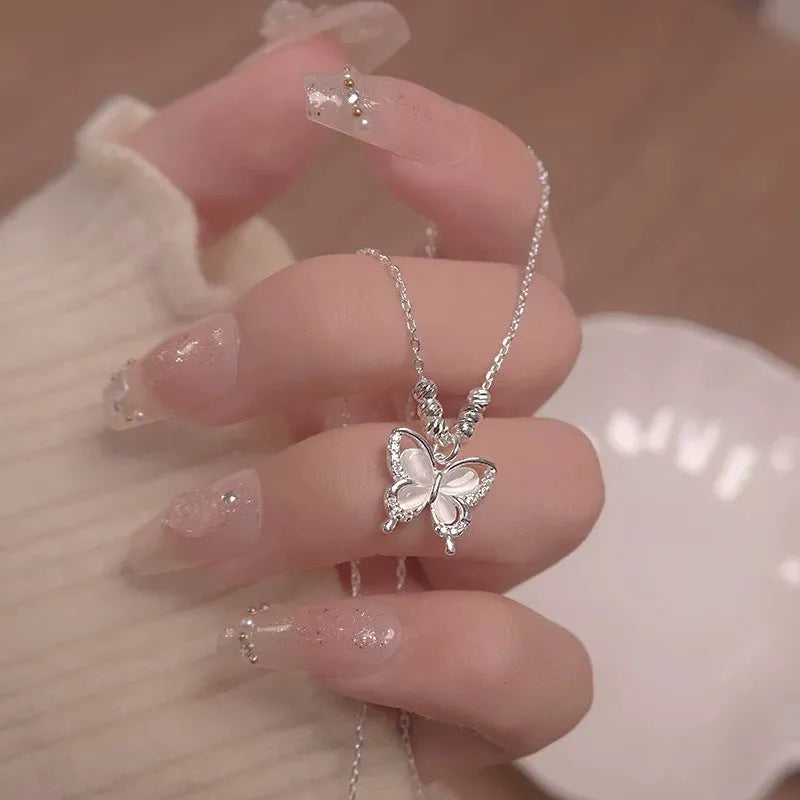 Women's square line opal butterfly pendant necklace on a silver adjustable cross chain.