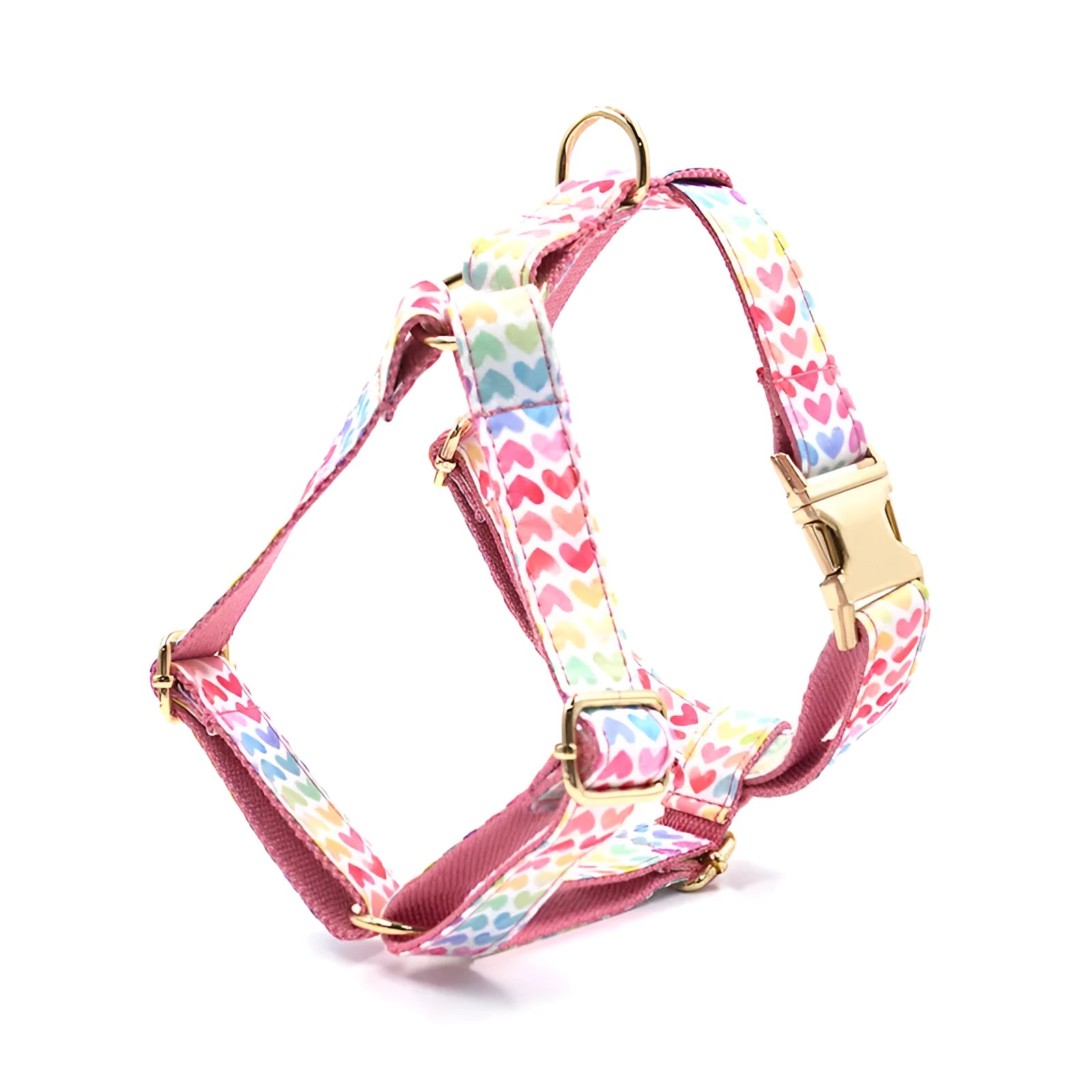 Pink colourful dog chest and back harness with gold buckle and heart-shaped stone details.