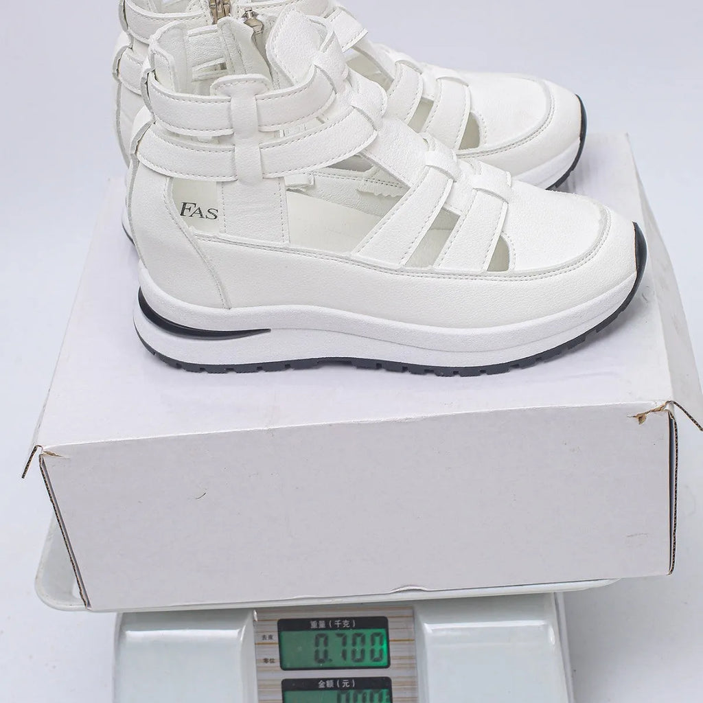 Black women's platform sandals with closed toe, hollow-out design and Velcro strap.