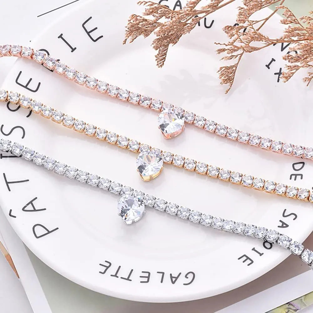 Gold heart-shaped rhinestone dog collar on a white background with an adjustable chain.