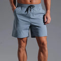 Men's loose straight-leg shorts in quick-dry polyester fabric showing four colour options