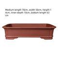 Large rectangular flowerpot made of thickened purple clay, showing its handmade texture and substantial size.