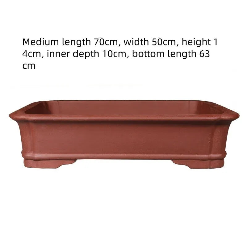 Large rectangular flowerpot made of thickened purple clay, showing its handmade texture and substantial size.