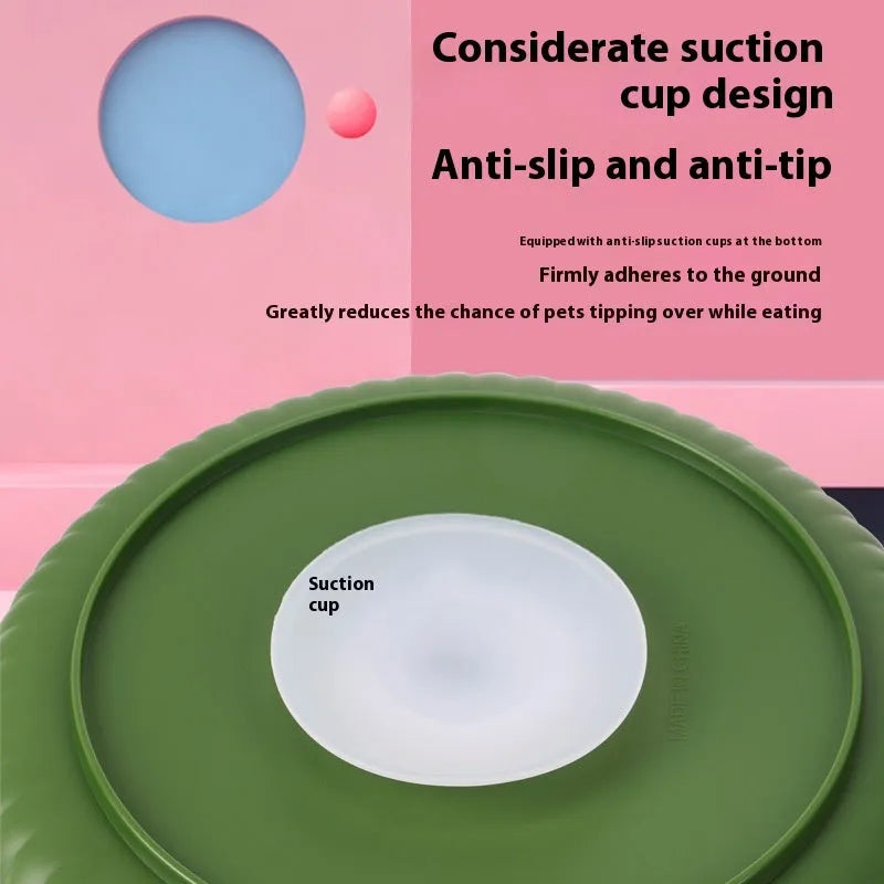 Rotating plastic pet feeding game board with blue silicone licking mat and a separate white bowl on a wooden table.