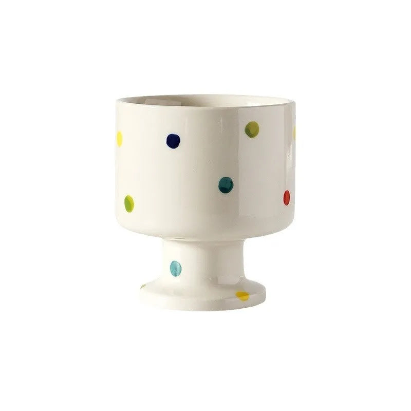 Hand-pinched irregular shaped ceramic mug in a solid colour on a plain background.