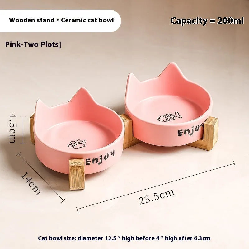 Porcelain cat bowl with cat ear and paw design on a wooden feeding frame, in pink colour.