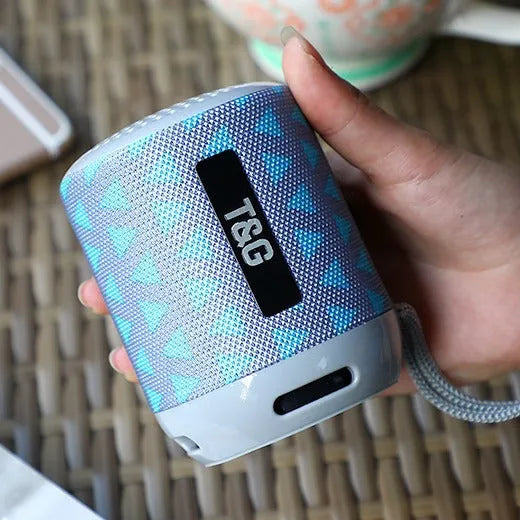 Wireless Bluetooth speaker in black, compact design with buttons and speaker grille, 73.4mm size