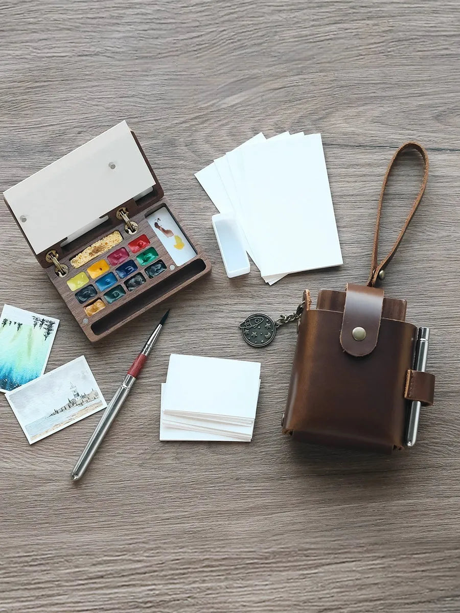 Mini walnut wood paint box open showing compartments for watercolour pigment pans.
