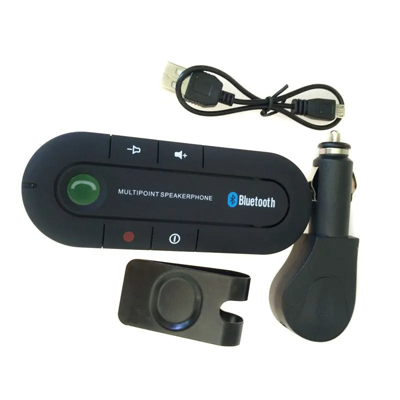 Black vehicle-mounted Bluetooth handsfree and music player device attached to a car sun visor.