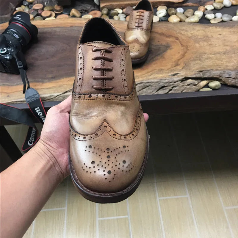 Light brown men's vintage distressed leather lace-up shoes with carved detailing on the upper.