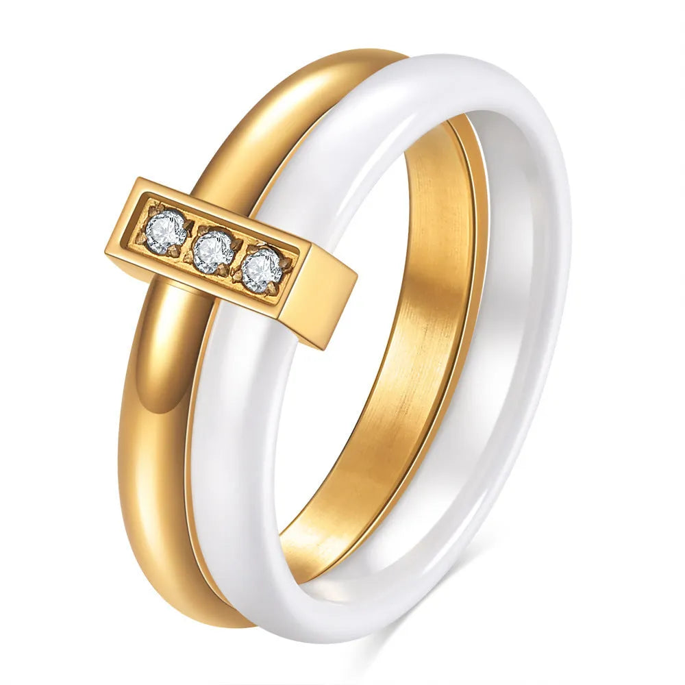 A Steel Black ceramic women's ring with glossy stitching and inlaid zirconium stones on a wooden surface.