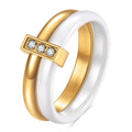 A Steel Black ceramic women's ring with glossy stitching and inlaid zirconium stones on a wooden surface.