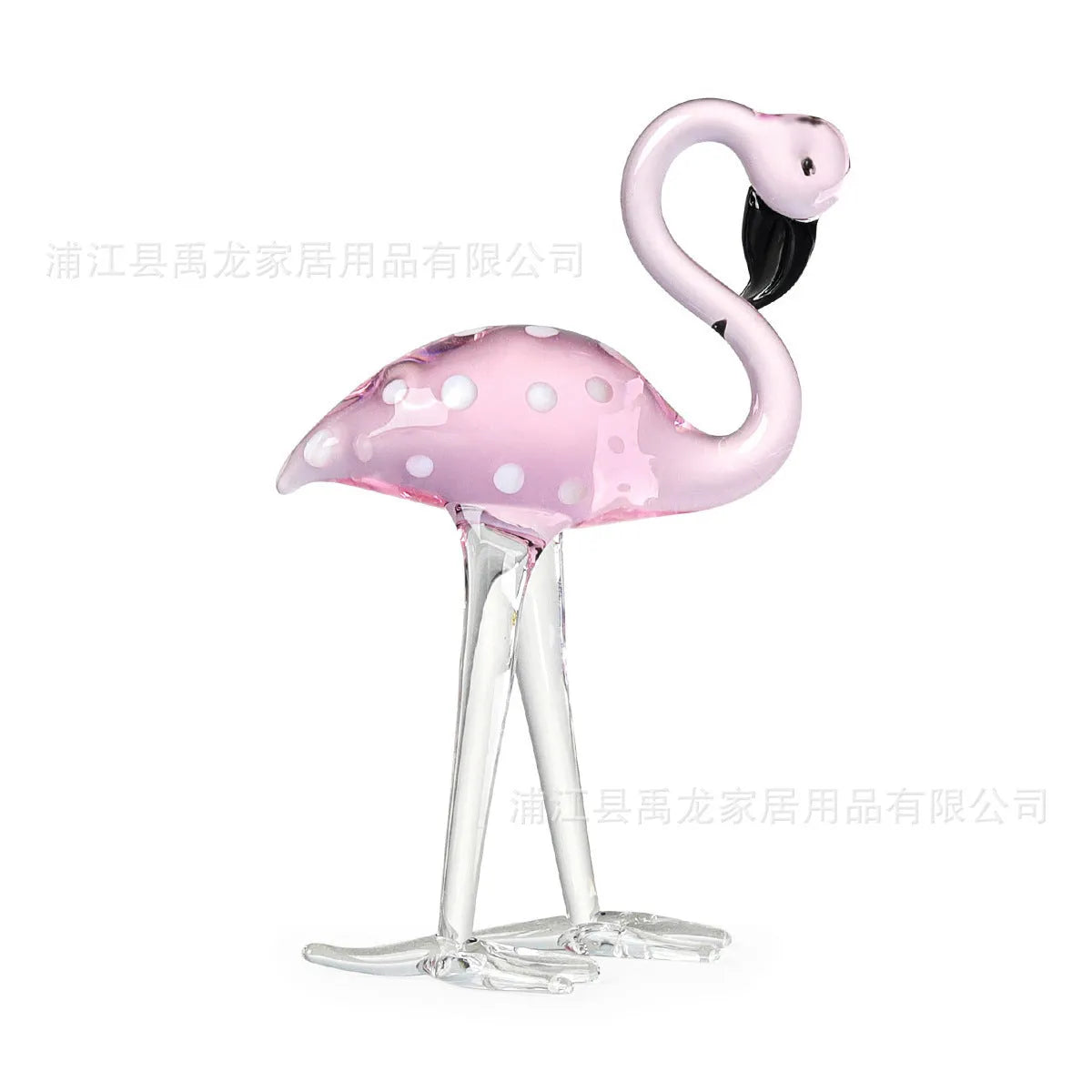 Pink and white crystal flamingo decorative ornament on a table.