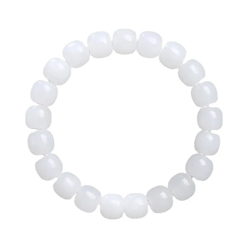 White Hetian jade barrel bead bracelet showing smooth, polished beads on a wrist.