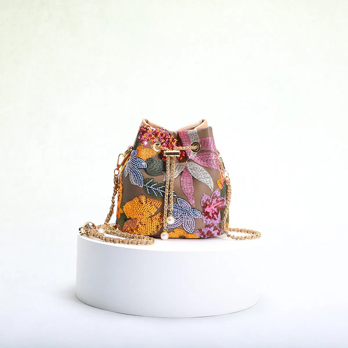 Bucket bag with mesh patchwork contrasting colours drawstring and chain strap in beige PVC material