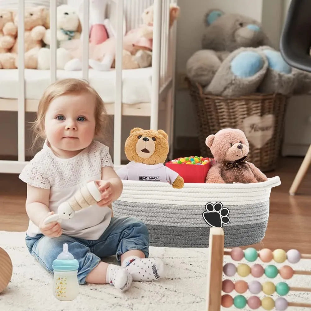 Small light beige woven cotton rope storage basket with wooden handles for organisation