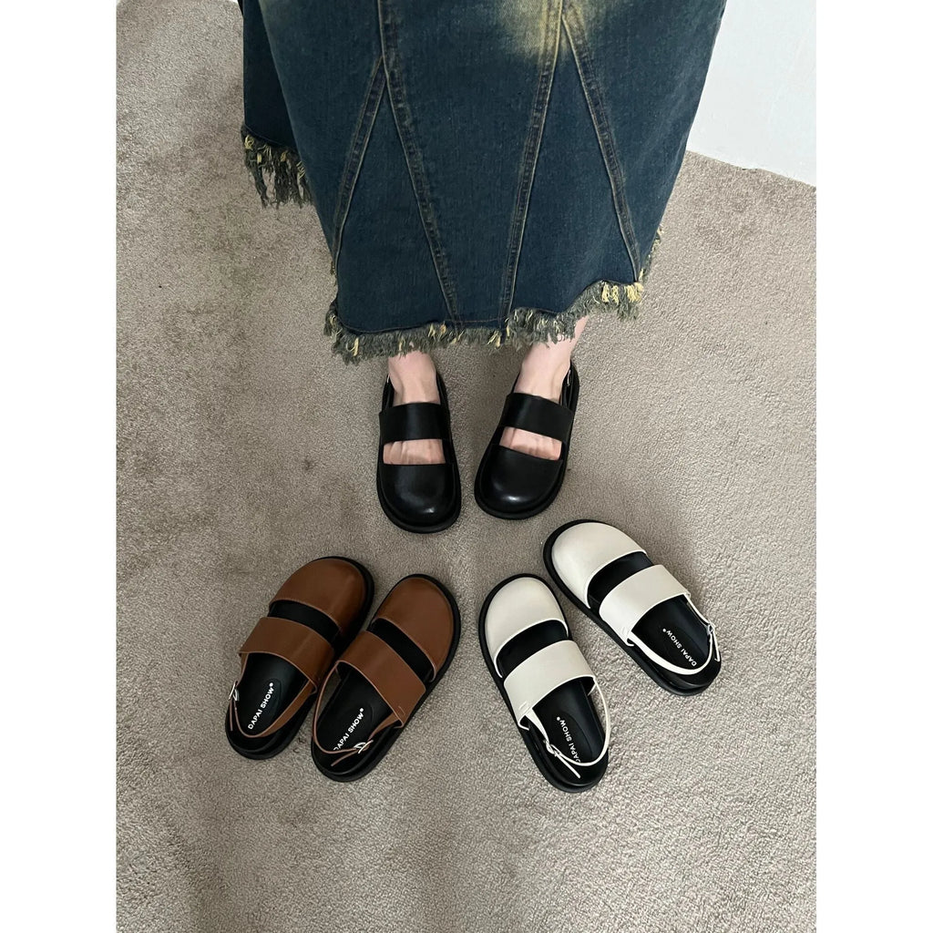Korean style women's retro sandals with a black microfiber upper and adjustable ankle buckle on a PVC sole.
